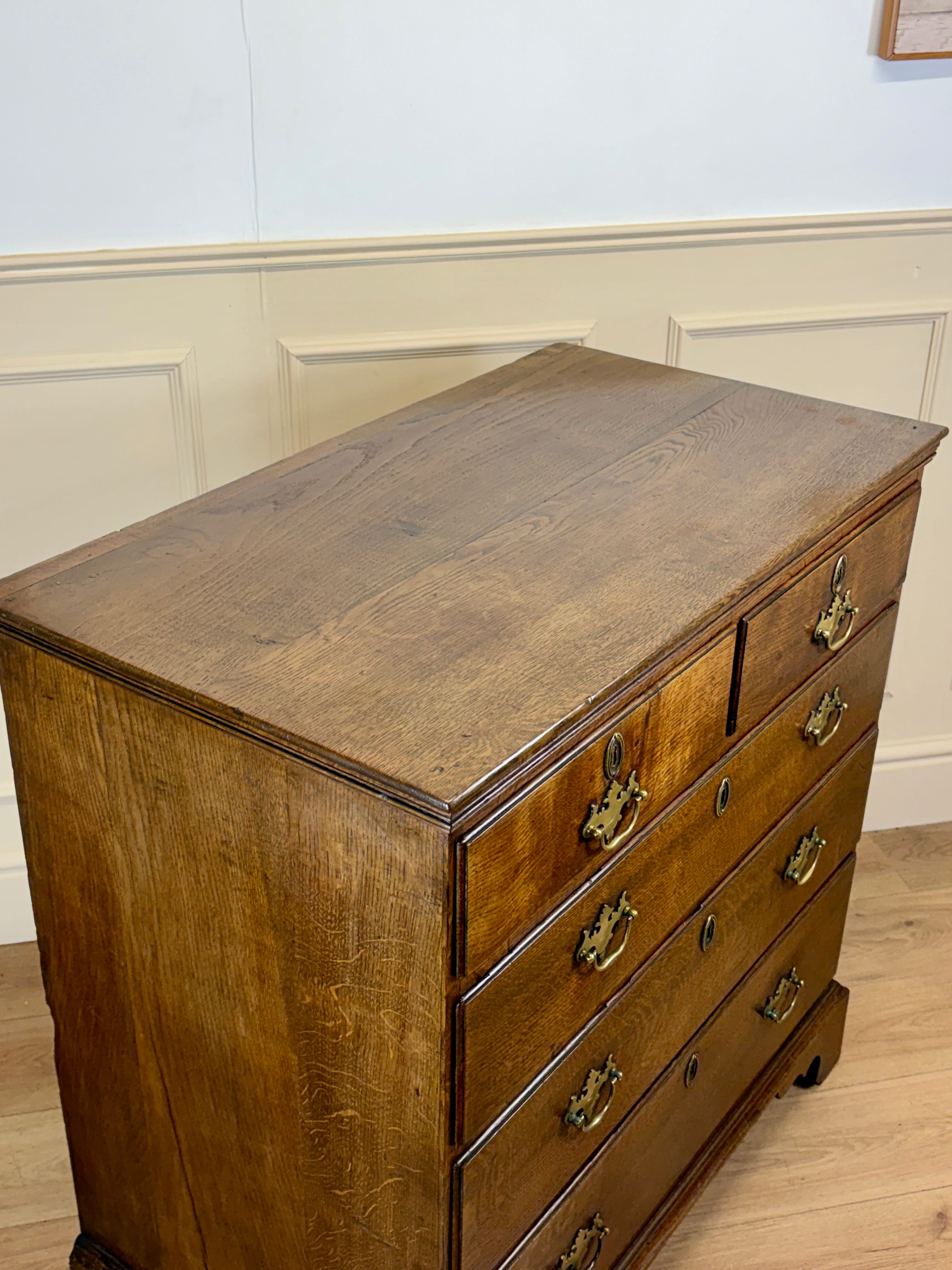 Antique light oak farmhouse chest of drawers with brass handles and patina