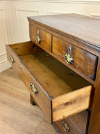Antique light oak farmhouse chest of drawers with brass handles and patina
