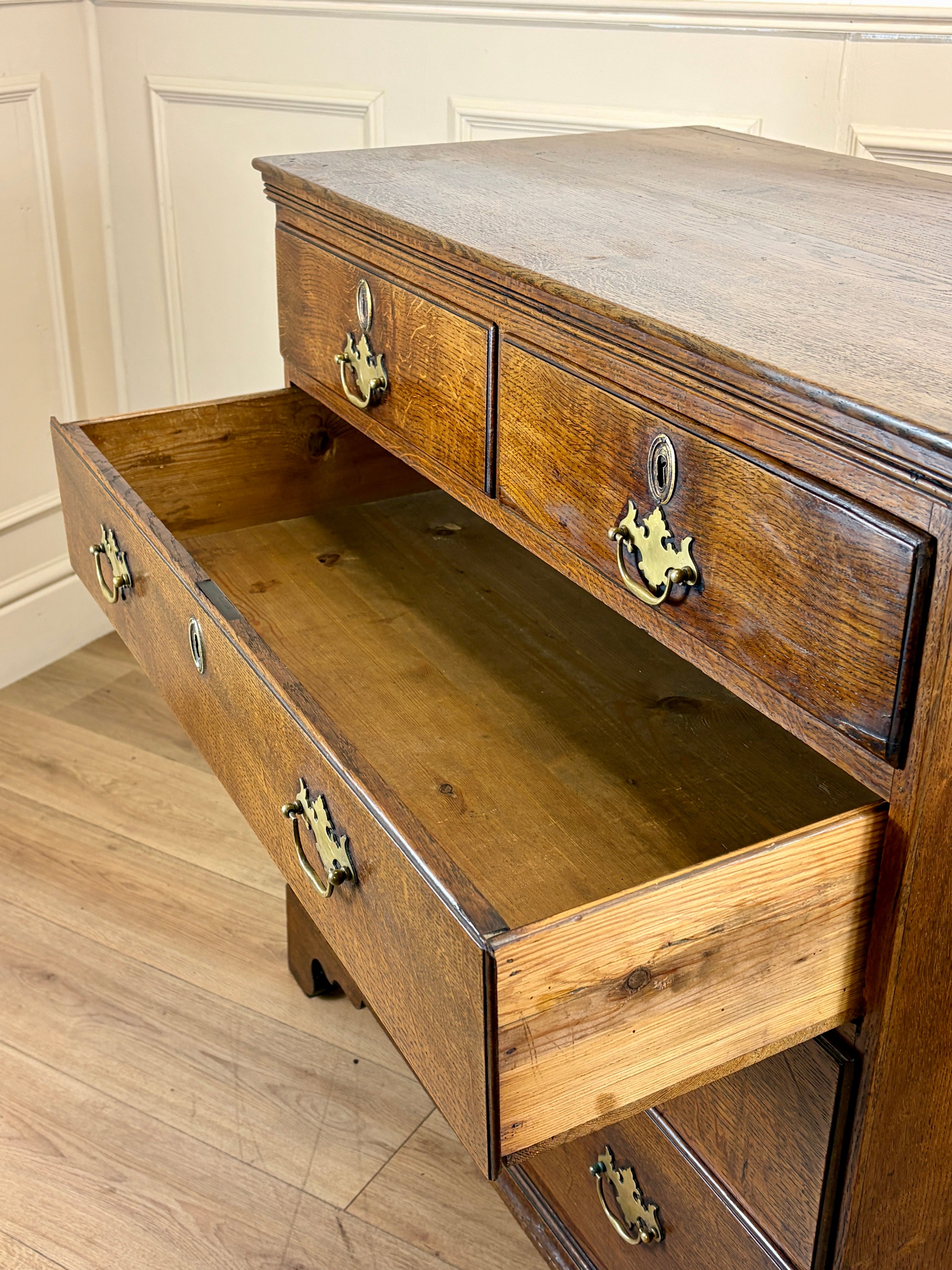Antique light oak farmhouse chest of drawers with brass handles and patina