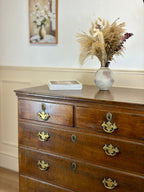 Antique light oak farmhouse chest of drawers with brass handles and patina