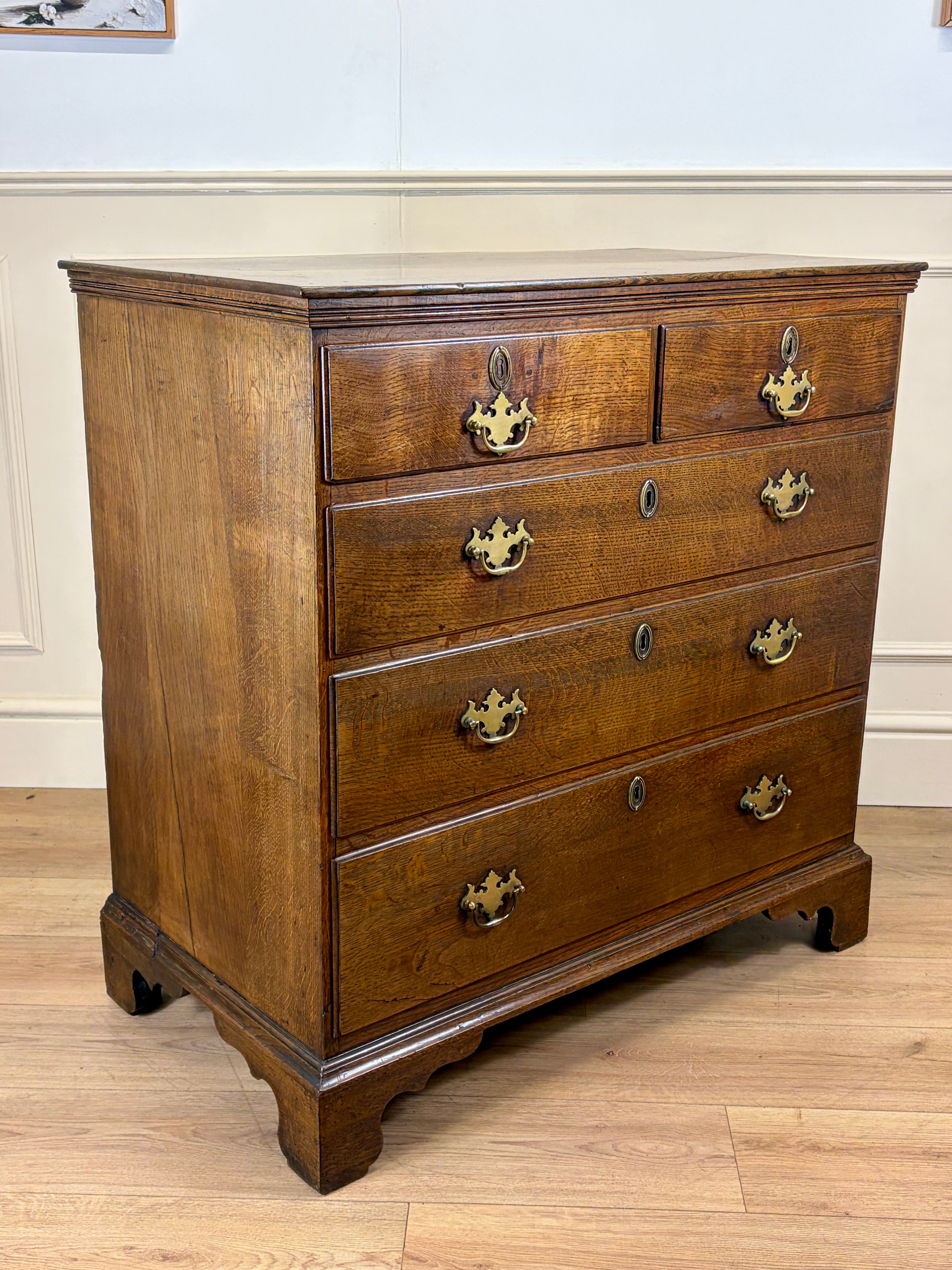 Antique light oak farmhouse chest of drawers with brass handles and patina