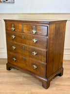 Antique light oak farmhouse chest of drawers with brass handles and patina