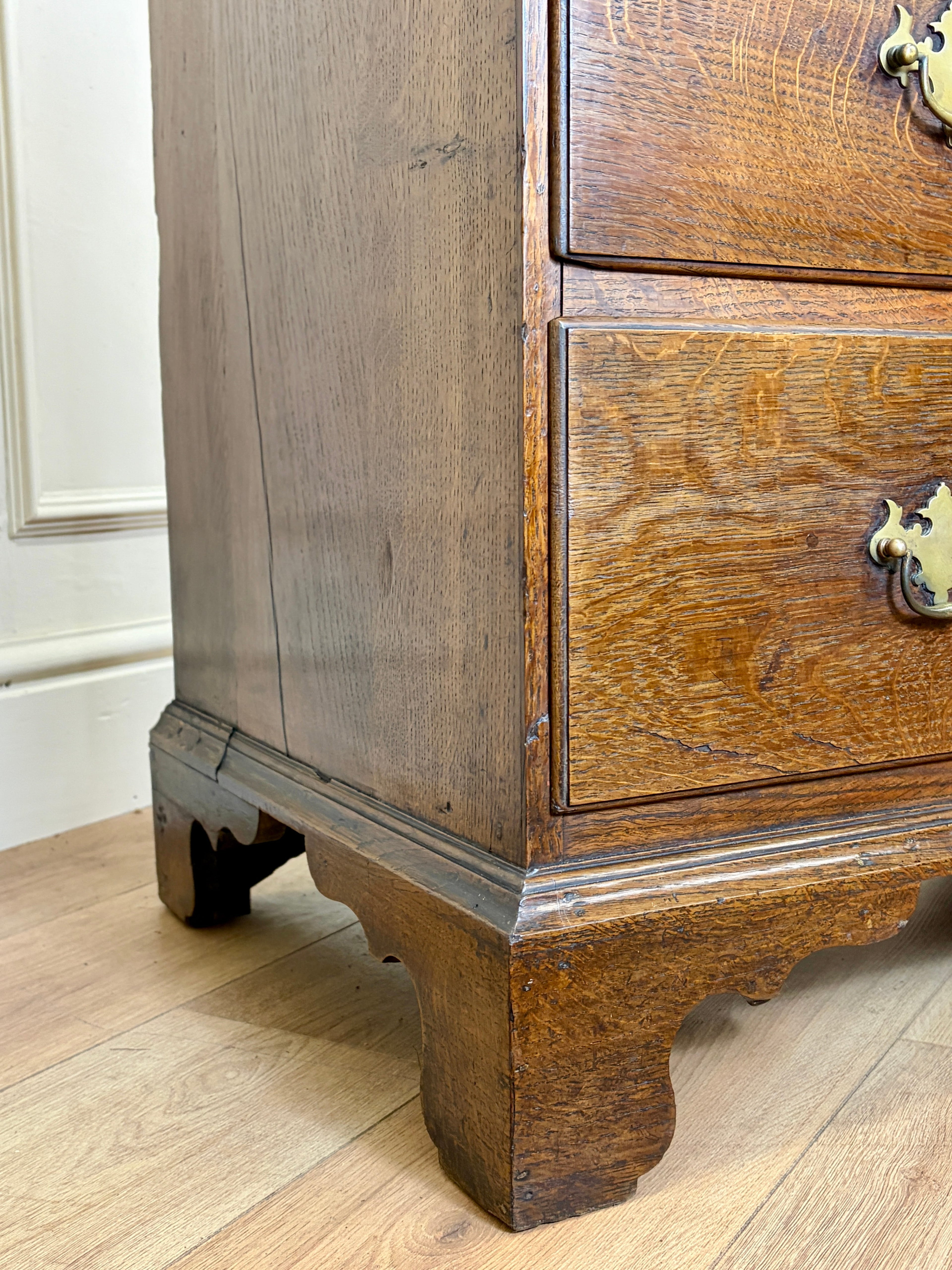 Antique light oak farmhouse chest of drawers with brass handles and patina