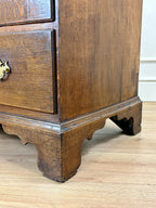 Antique light oak farmhouse chest of drawers with brass handles and patina