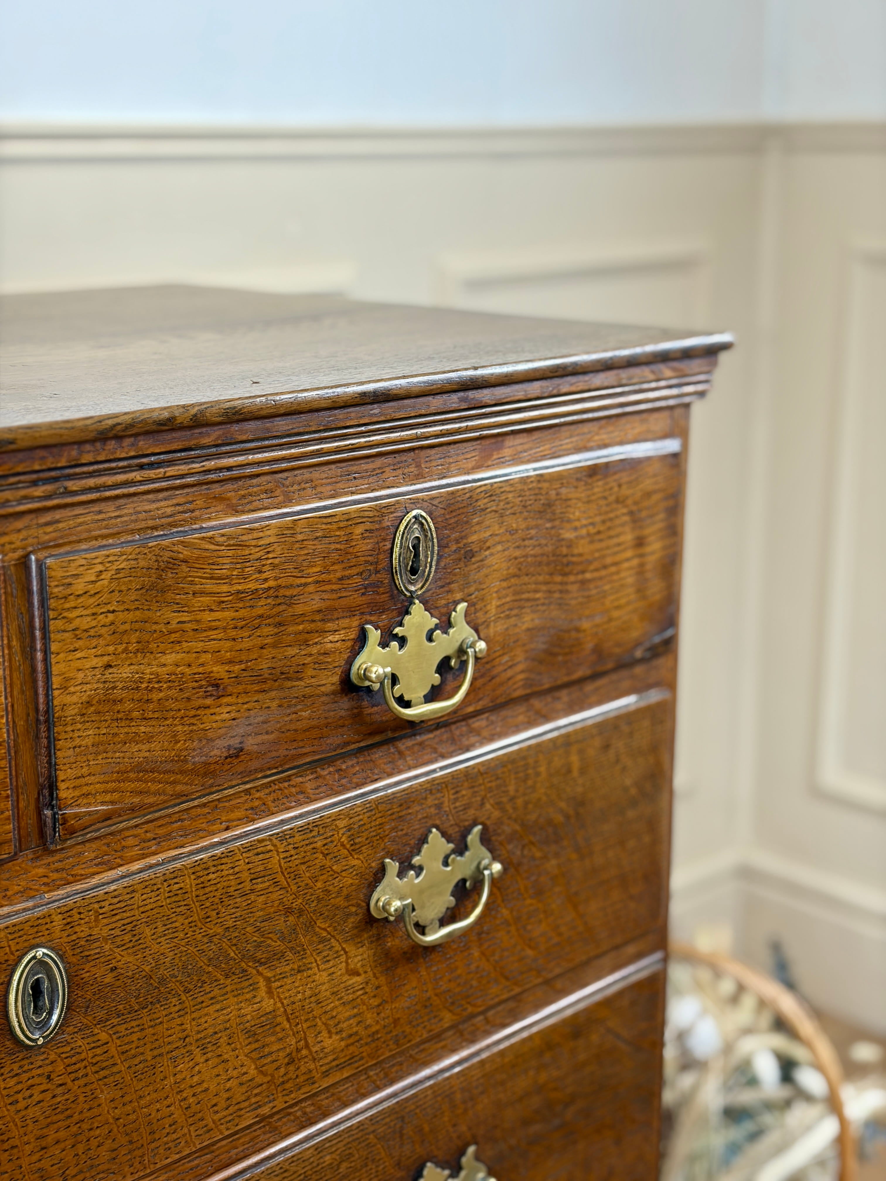 Antique light oak farmhouse chest of drawers with brass handles and patina