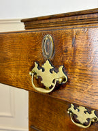 Antique light oak farmhouse chest of drawers with brass handles and patina