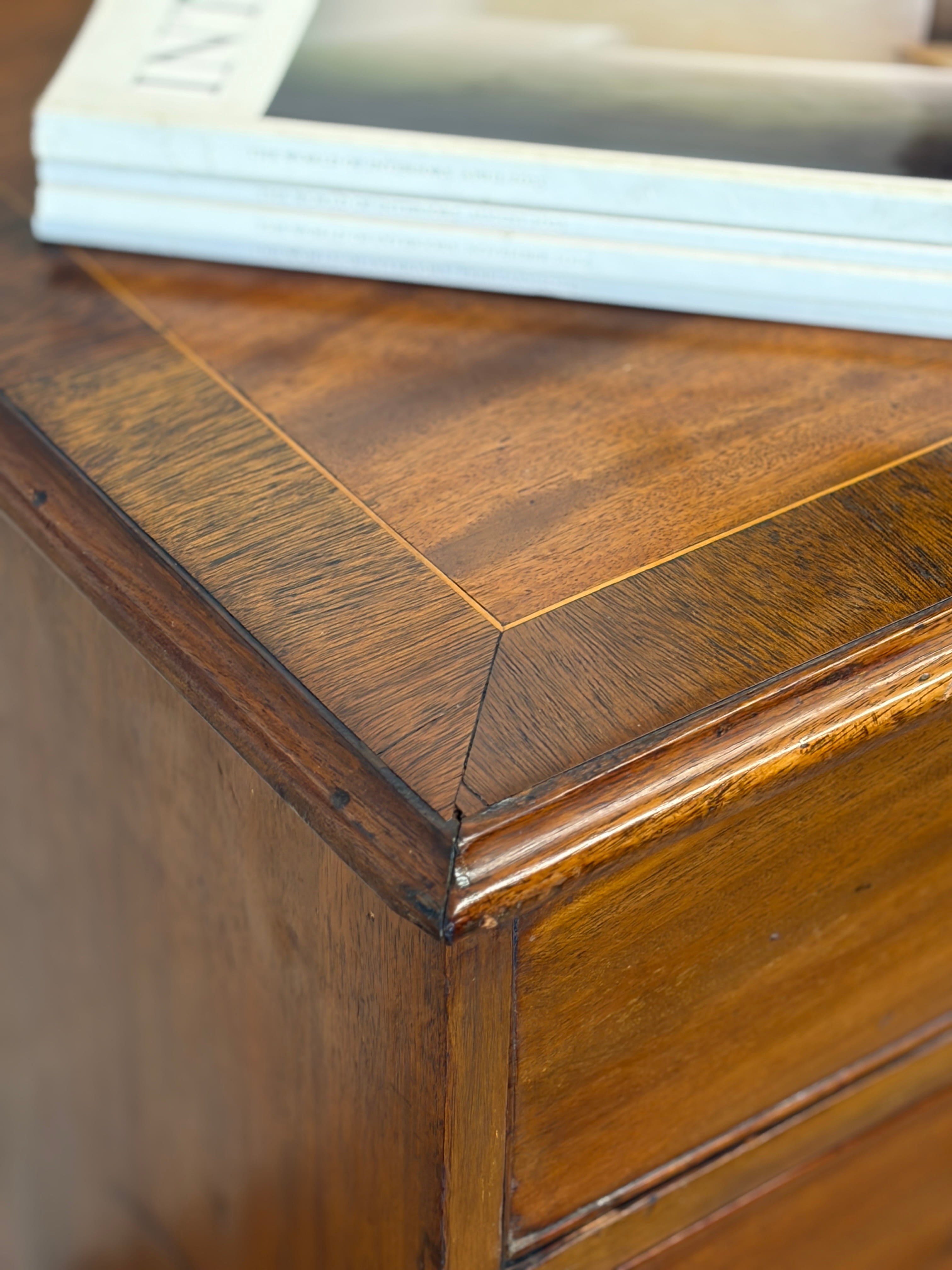 Close-up of a wooden surface with a book in the background