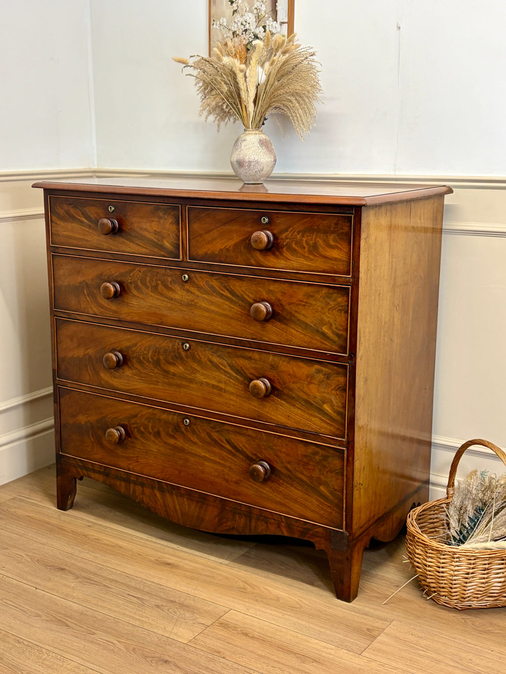 Wooden dresser with decorative items on a wooden floor