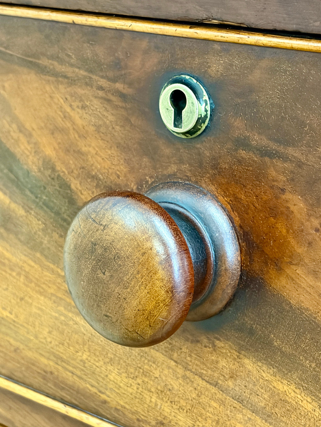 Wooden door with a brass doorknob and keyhole