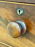 Wooden door with a brass doorknob and keyhole