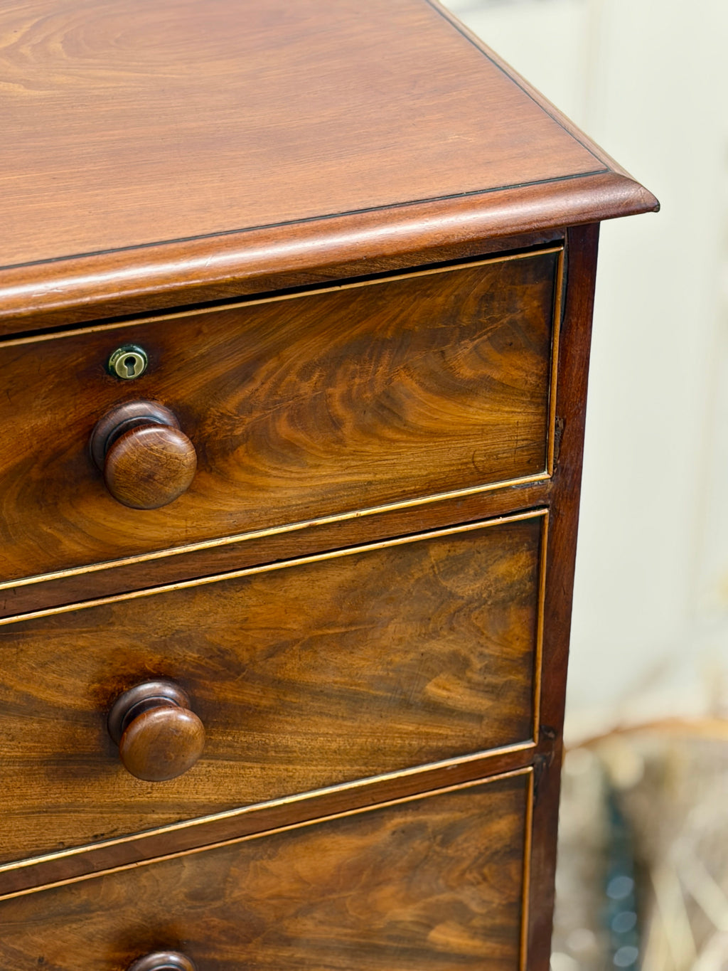 Wooden dresser with three drawers and visible grain pattern.