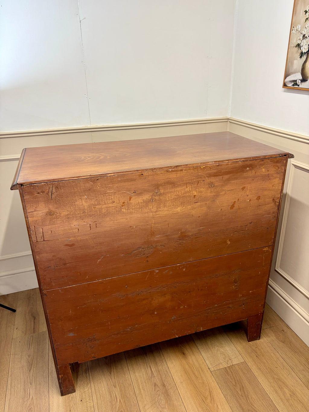 Wooden chest on a wooden floor with a white wall background
