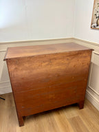 Wooden chest on a wooden floor with a white wall background