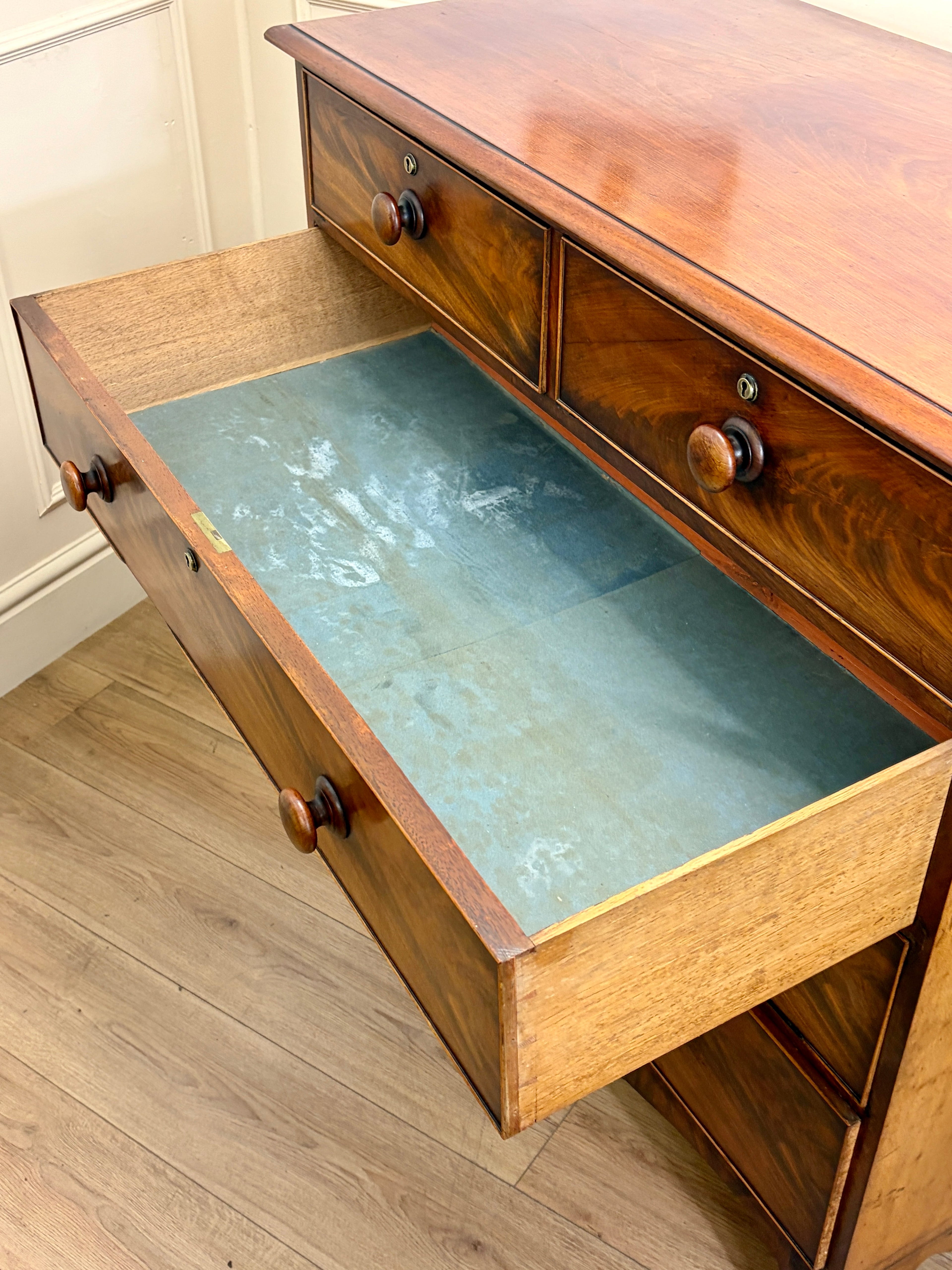 Wooden desk with glass top on a wooden floor