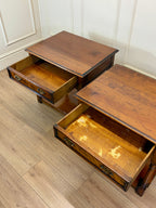 Two wooden step stools with drawers on a wooden floor.