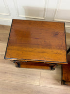 Wooden table with a worn surface on a wooden floor.