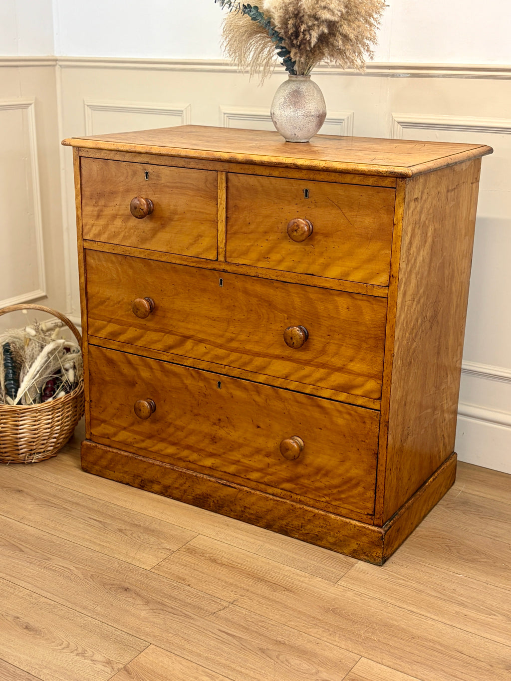 Wooden dresser with three drawers on a wooden floor