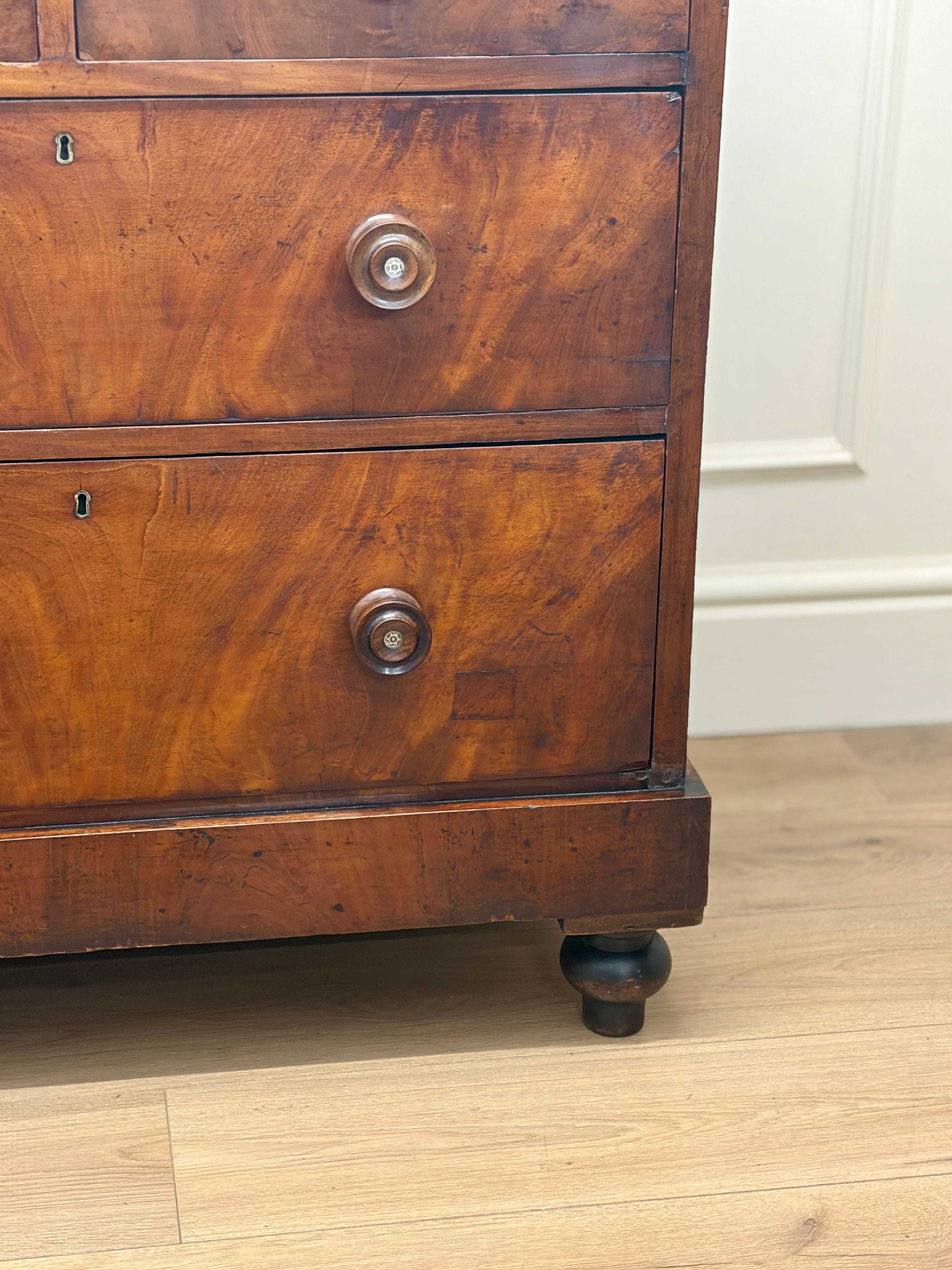 Wooden dresser with two drawers on a wooden floor.