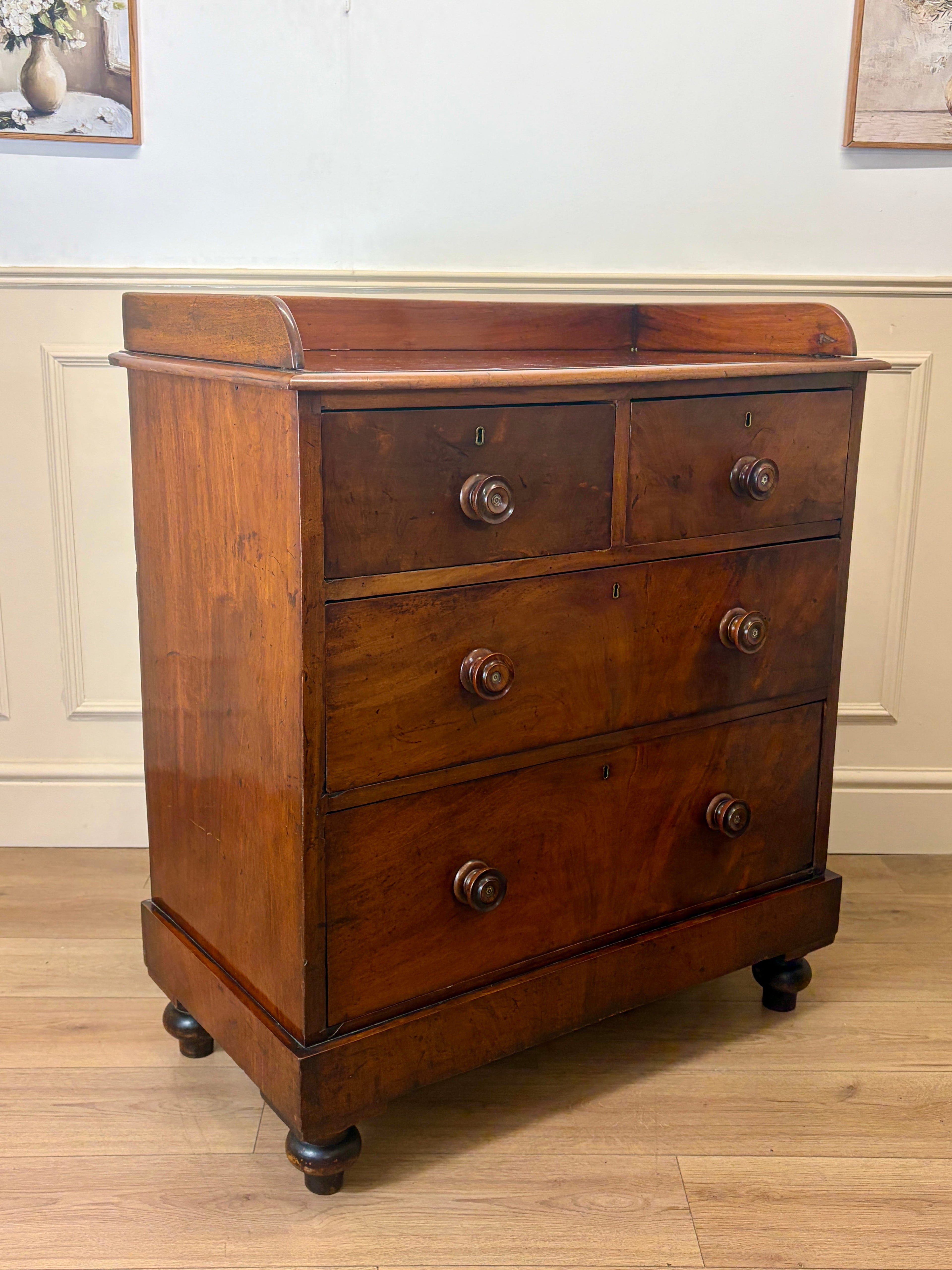 Wooden dresser with three drawers on a wooden floor.