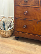 Wooden dresser with wicker basket on a wooden floor