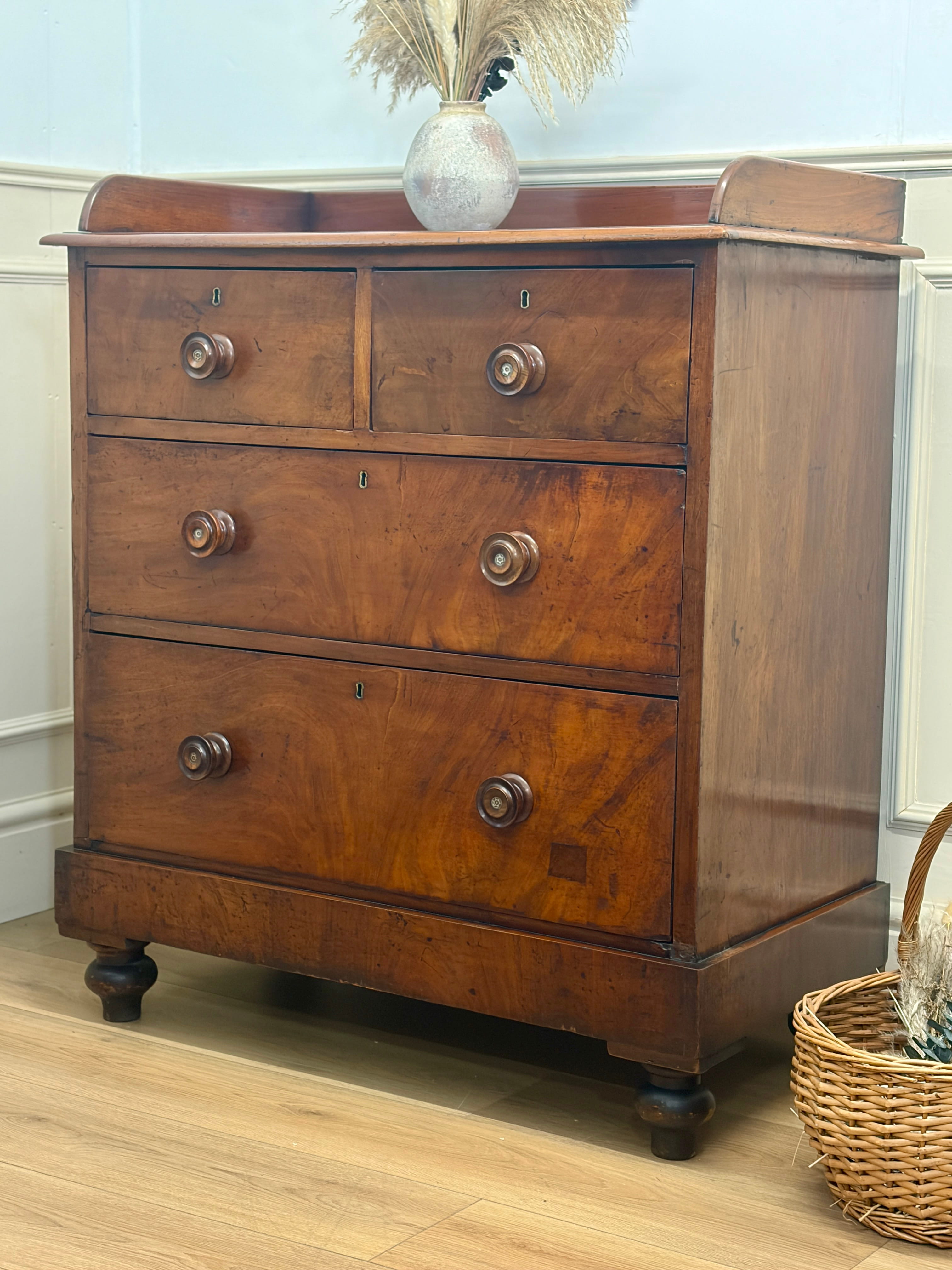 Wooden dresser with three drawers on a wooden floor.