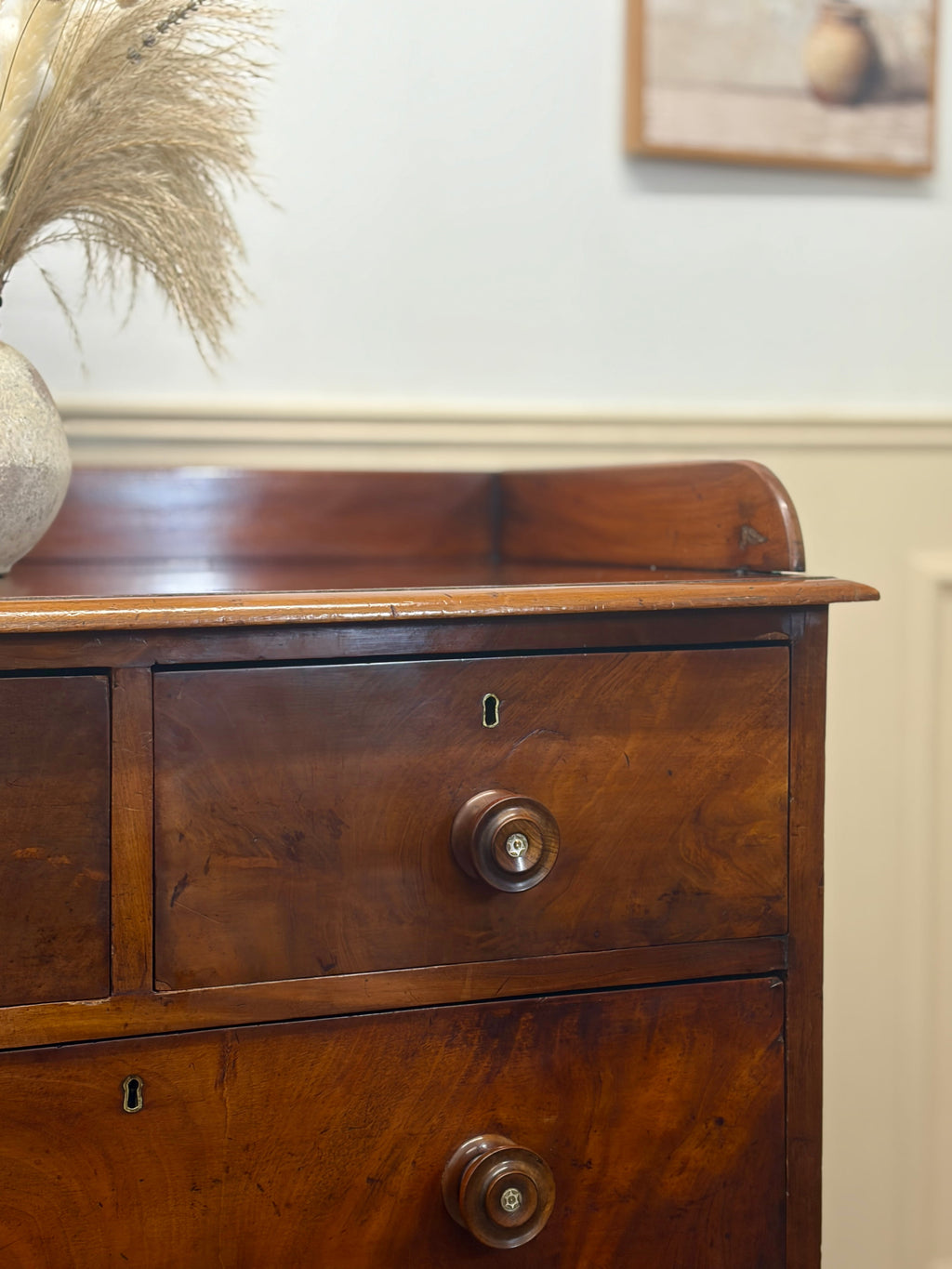 Wooden dresser with two drawers and a mirror in the background