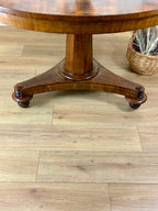 Wooden table on a wooden floor with a wicker basket in the background