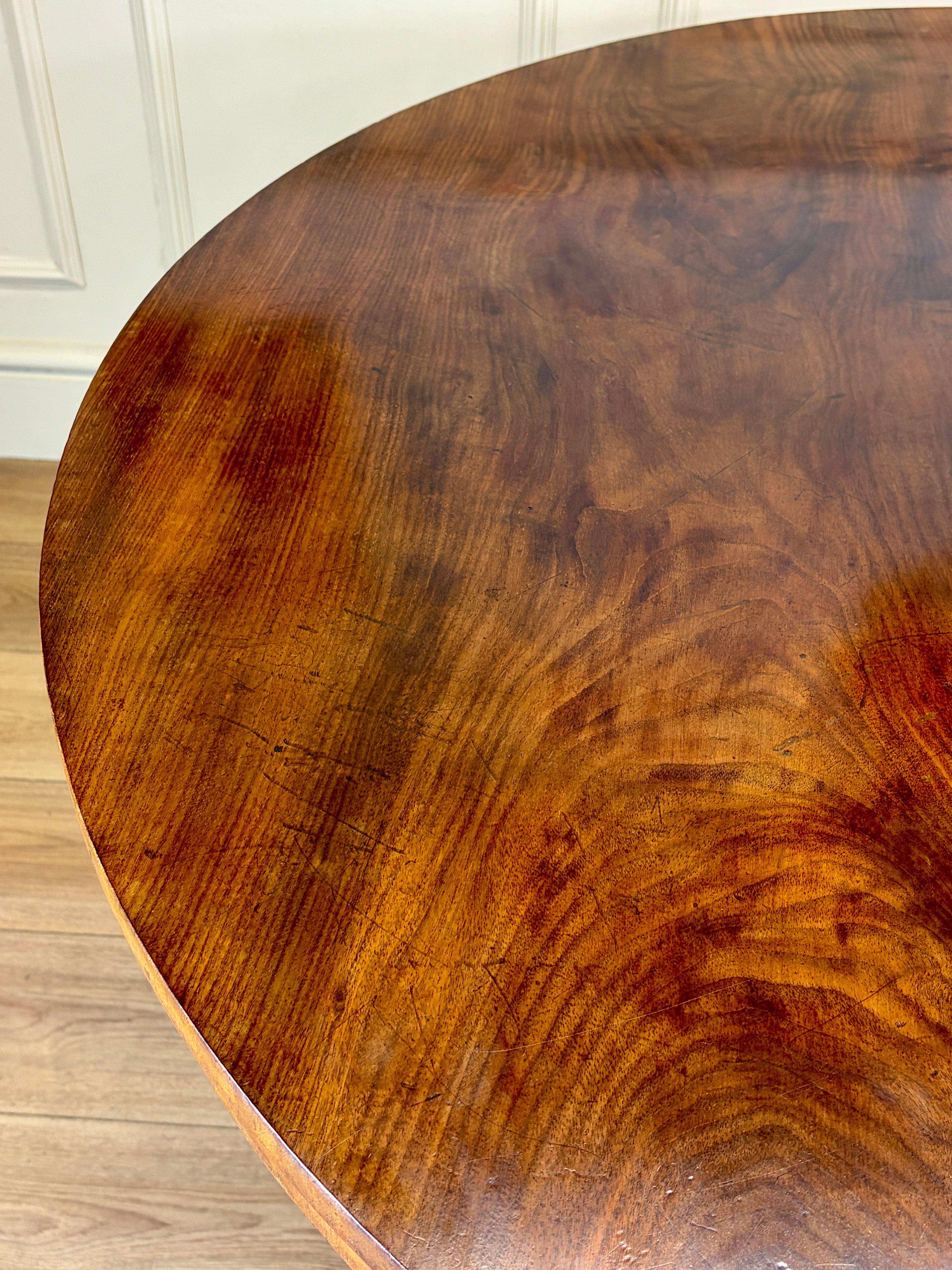 Close-up of a wooden table with visible grain and texture.