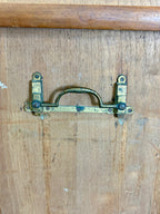 Brass door handle on a wooden door