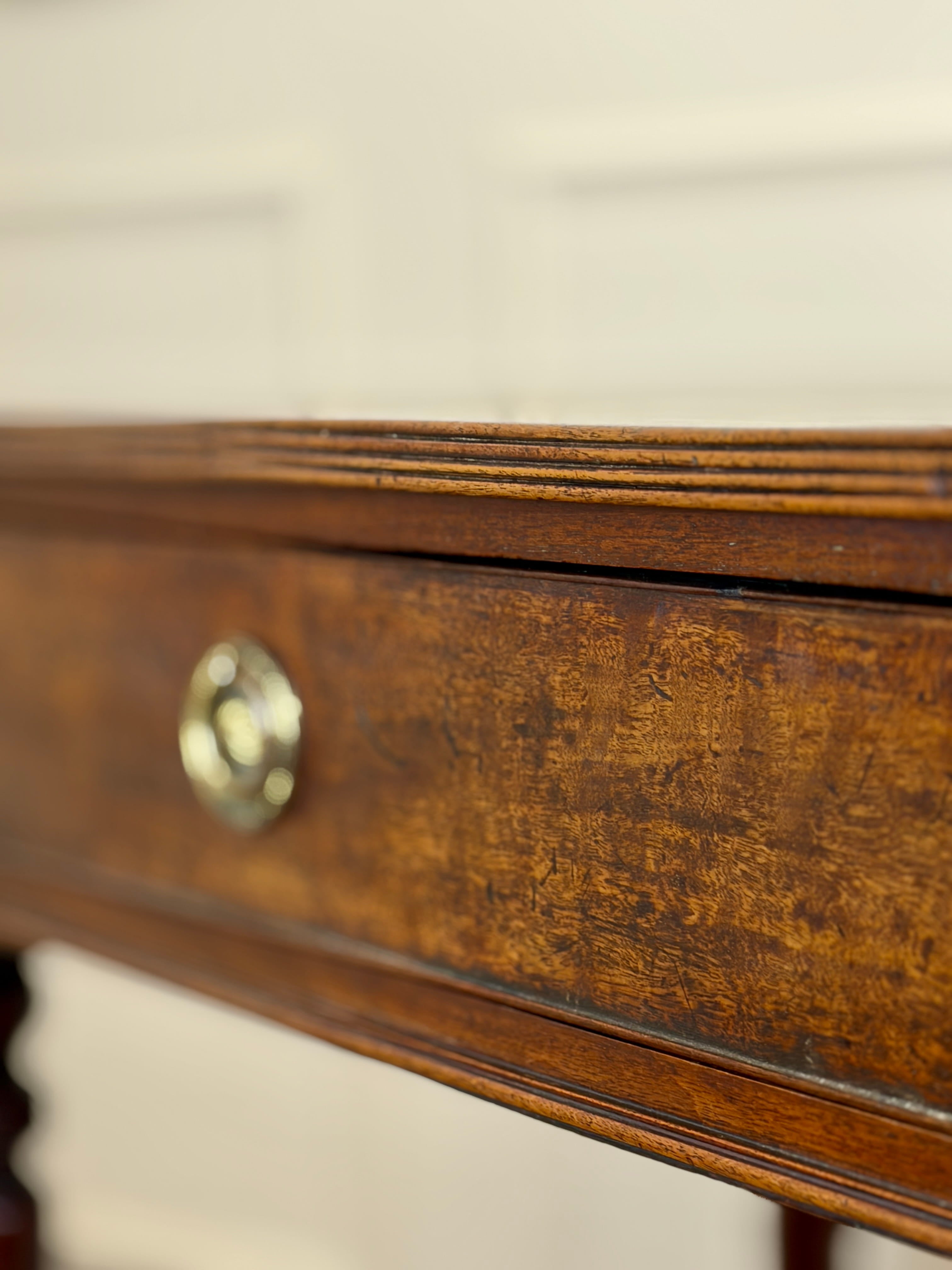 Close-up of a wooden drawer with a brass handle on a blurred background