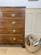 Angled view showing antique mahogany chest of drawers for bedroom with graduated drawers and Prince of Wales brasses