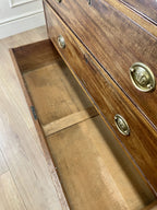 Angled view showing antique mahogany chest of drawers for bedroom with graduated drawers and Prince of Wales brasses