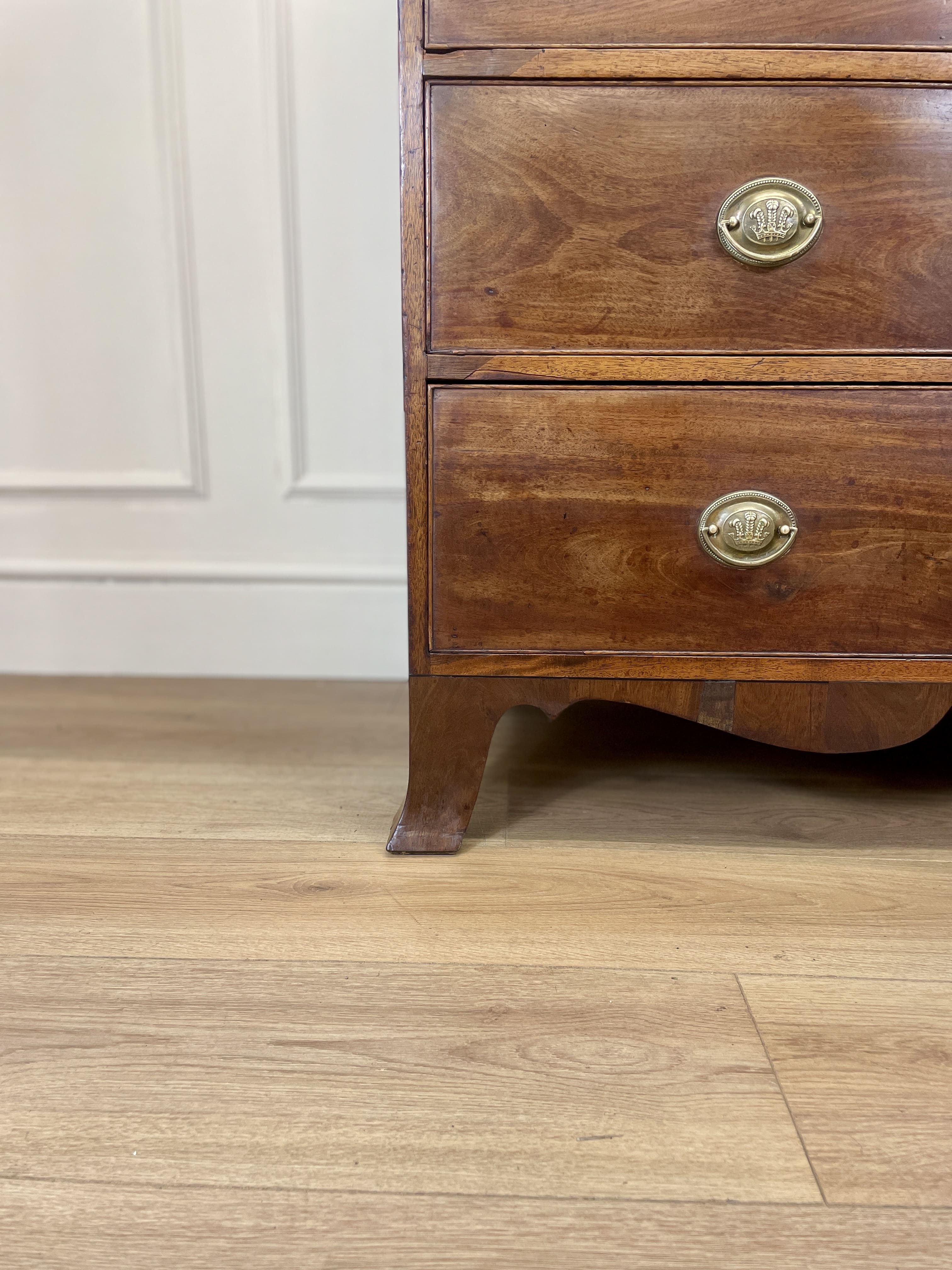 Angled view showing antique mahogany chest of drawers for bedroom with graduated drawers and Prince of Wales brasses