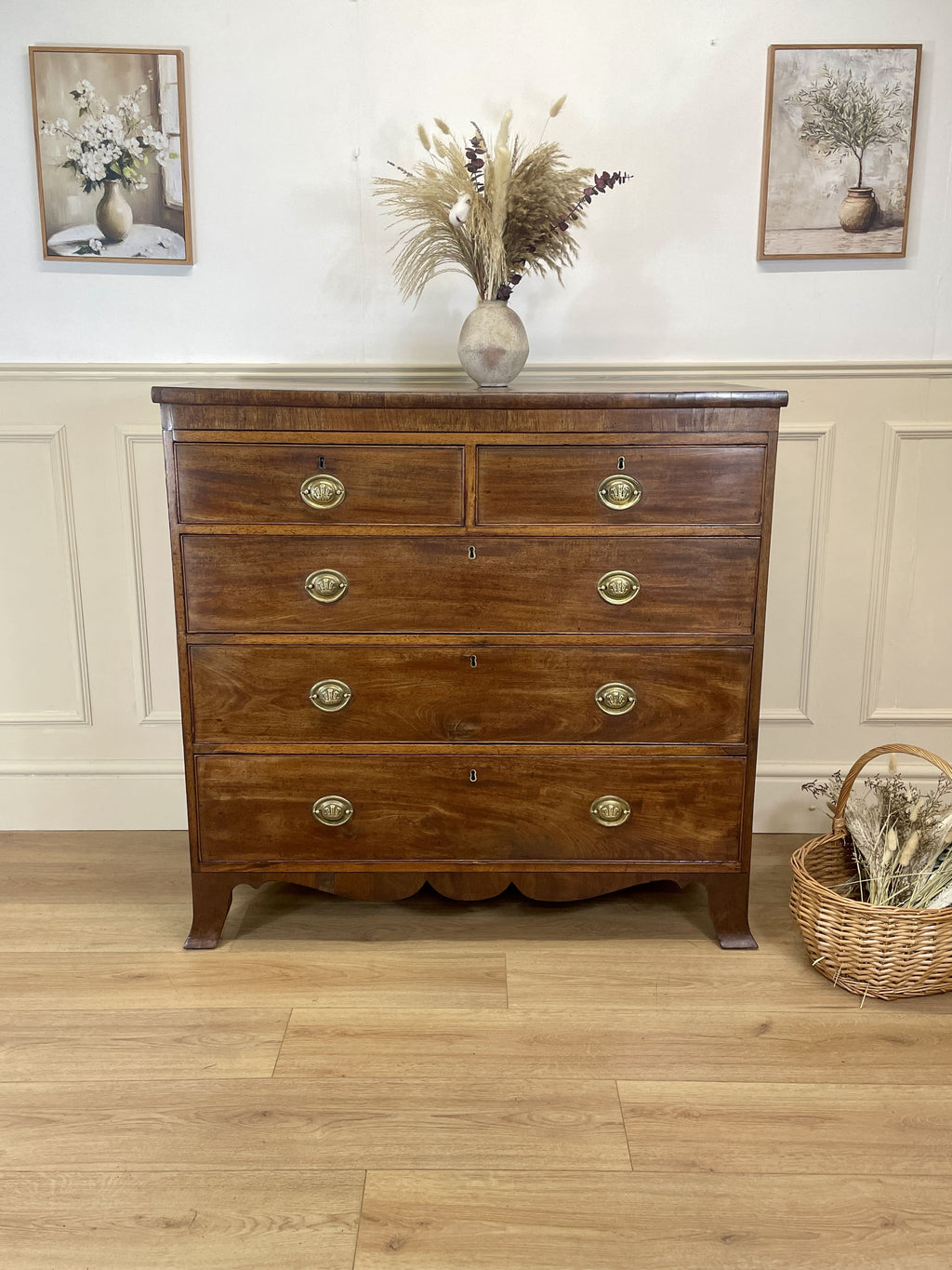 Angled view showing antique mahogany chest of drawers for bedroom with graduated drawers and Prince of Wales brasses