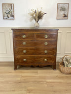 Angled view showing antique mahogany chest of drawers for bedroom with graduated drawers and Prince of Wales brasses