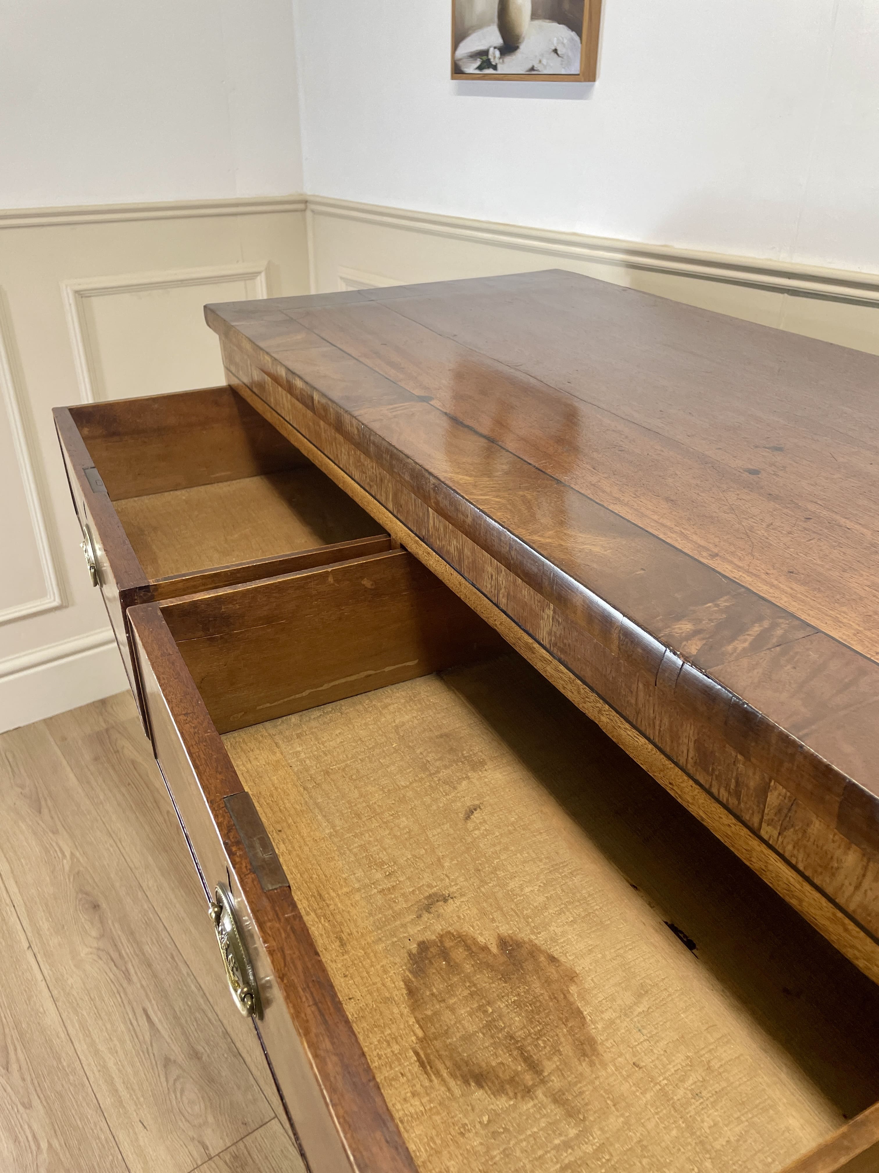 Angled view showing antique mahogany chest of drawers for bedroom with graduated drawers and Prince of Wales brasses