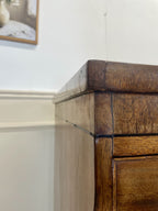 Angled view showing antique mahogany chest of drawers for bedroom with graduated drawers and Prince of Wales brasses