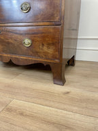 Angled view showing antique mahogany chest of drawers for bedroom with graduated drawers and Prince of Wales brasses