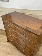 Angled view showing antique mahogany chest of drawers for bedroom with graduated drawers and Prince of Wales brasses