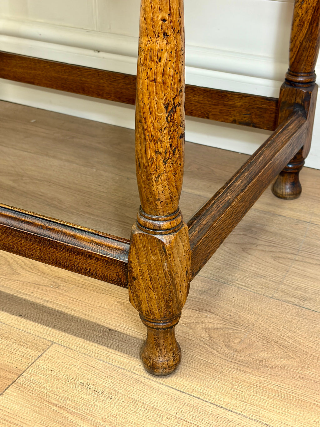 Close-up of a wooden chair leg on a wooden floor