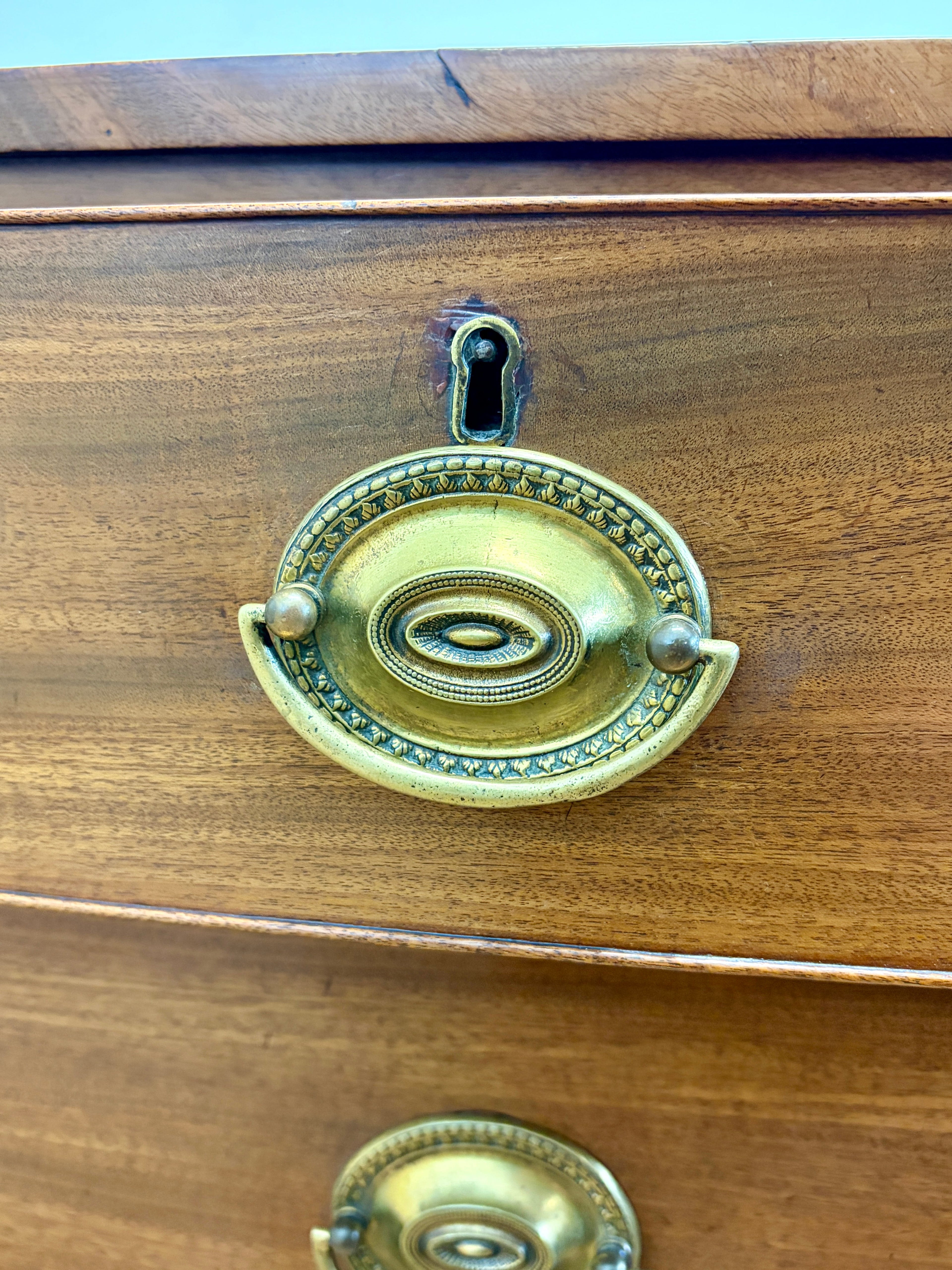 Wooden drawer with brass handles and keyhole