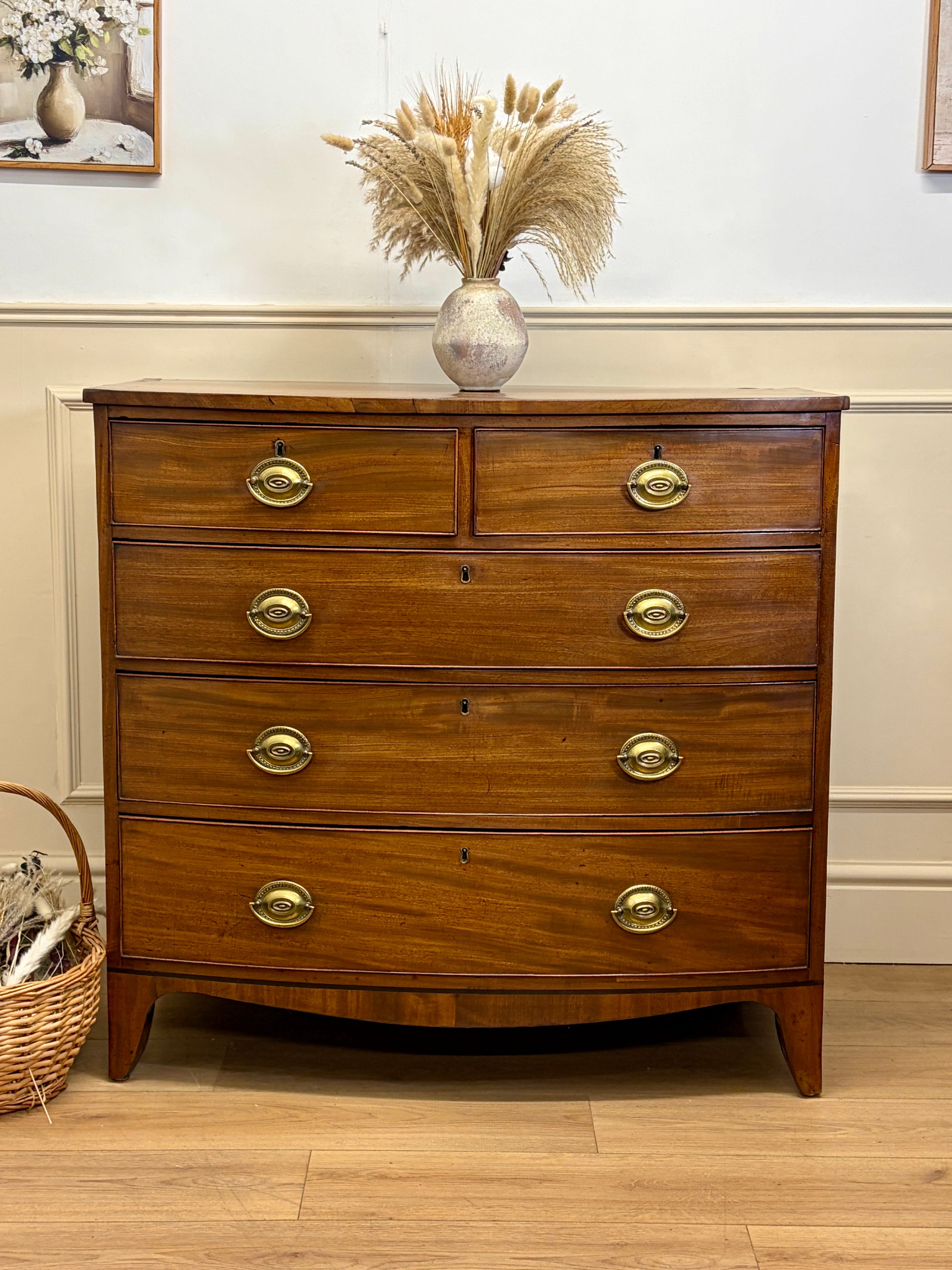 Wooden dresser with gold handles in a room setting