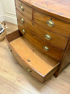 Wooden dresser with open drawer on a wooden floor