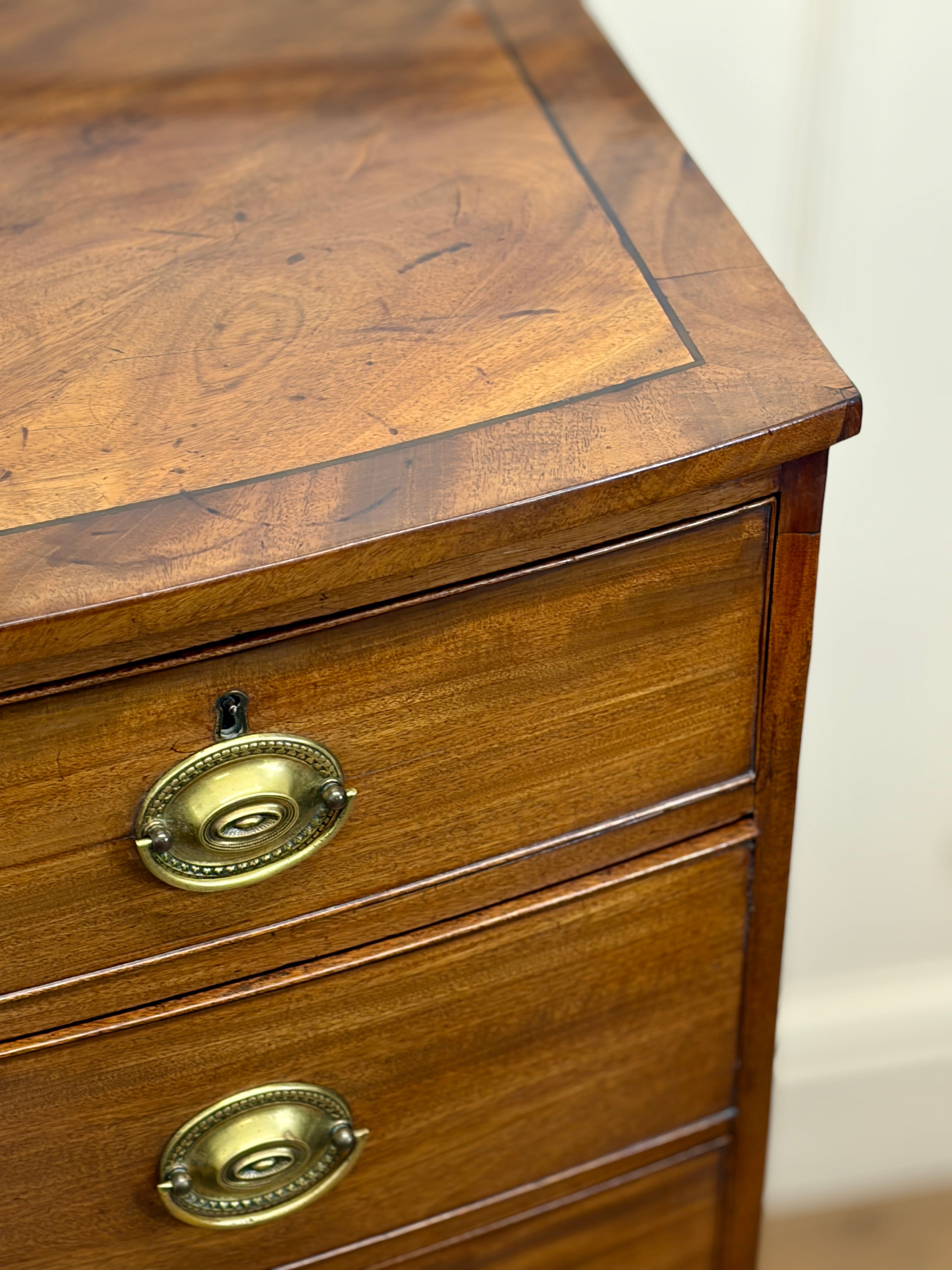 Wooden drawer with brass handles on a blurred background