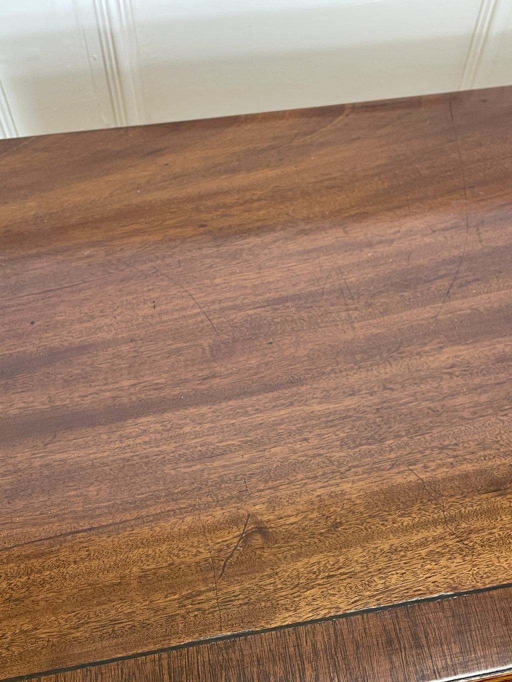 Angled view of late 19th century mahogany farmhouse chest of drawers with shaped bracket feet and elegant country furniture styling.