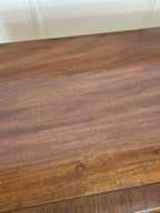 Angled view of late 19th century mahogany farmhouse chest of drawers with shaped bracket feet and elegant country furniture styling.