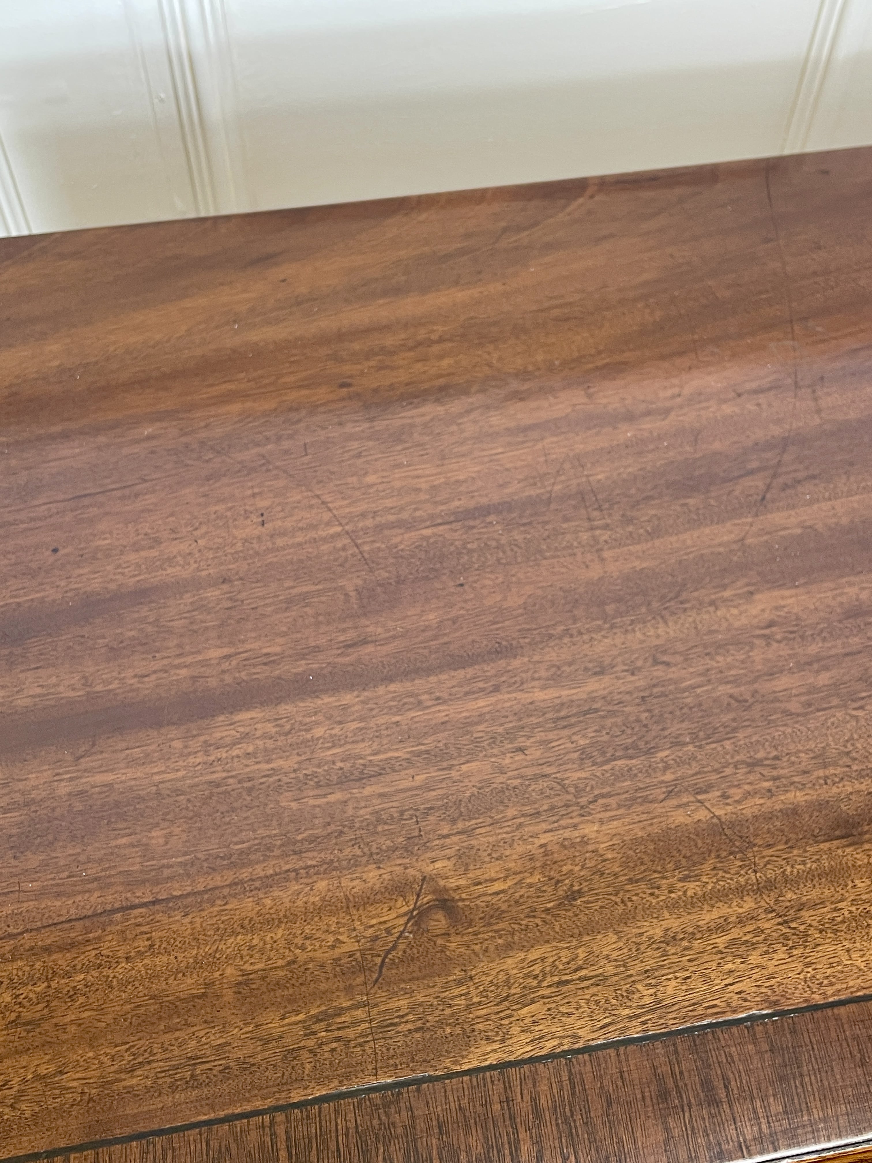 Angled view of late 19th century mahogany farmhouse chest of drawers with shaped bracket feet and elegant country furniture styling.