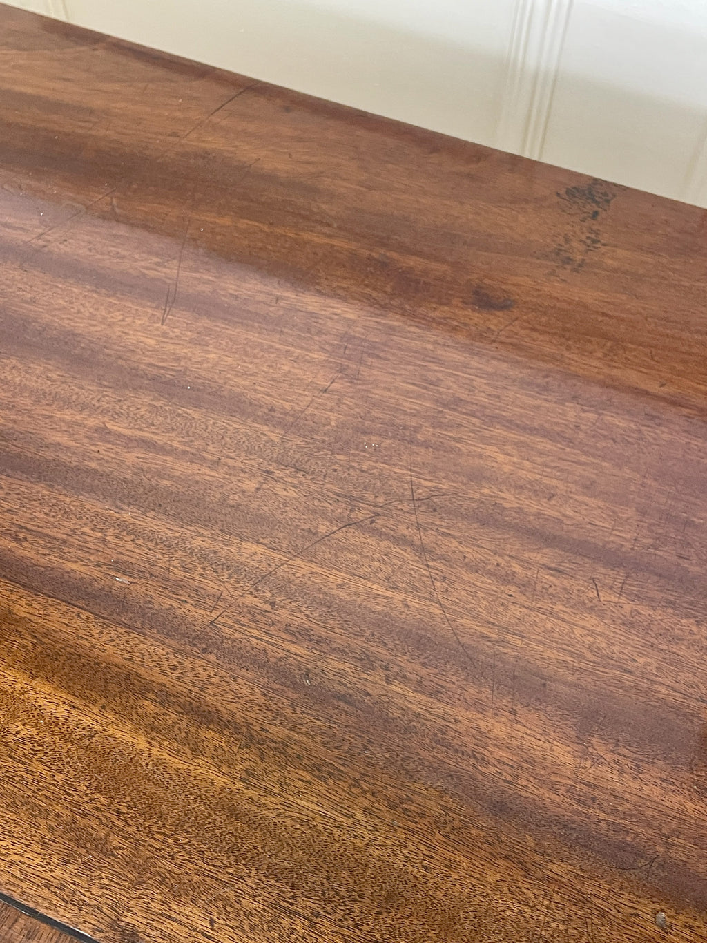 Angled view of late 19th century mahogany farmhouse chest of drawers with shaped bracket feet and elegant country furniture styling.