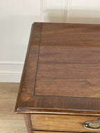 Angled view of late 19th century mahogany farmhouse chest of drawers with shaped bracket feet and elegant country furniture styling.