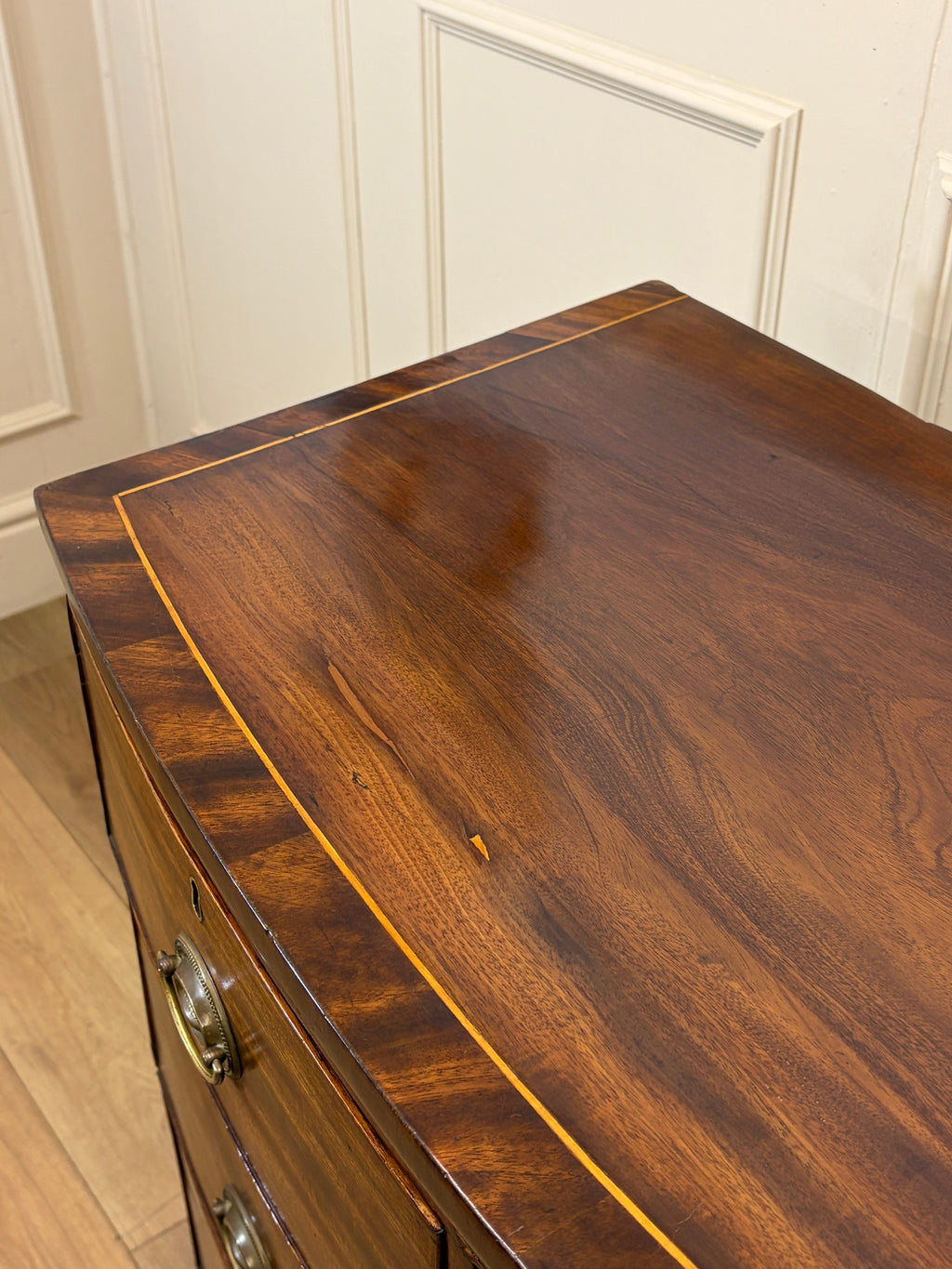 Wooden dresser with a focus on the top surface in a room setting.